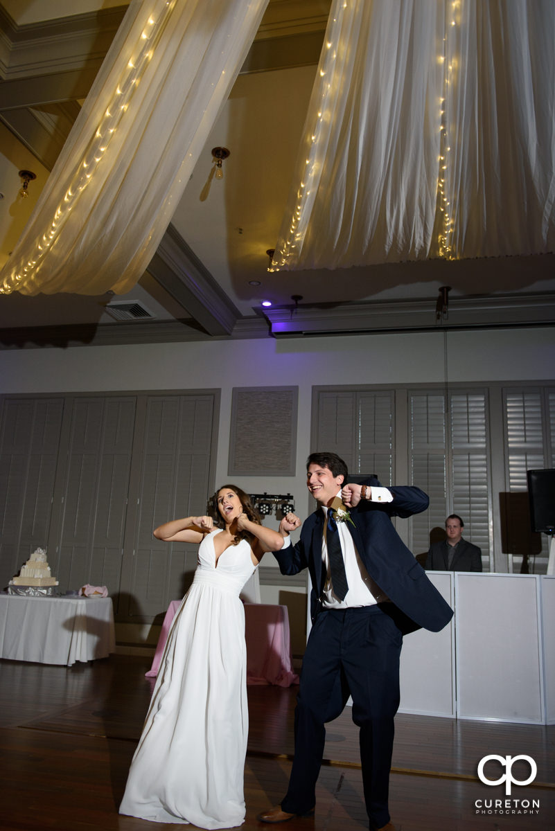 Bride and groom having a fun first dance at the reception.