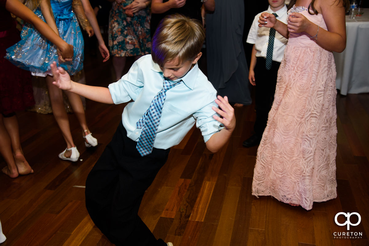 Boy dancing at the wedding reception.