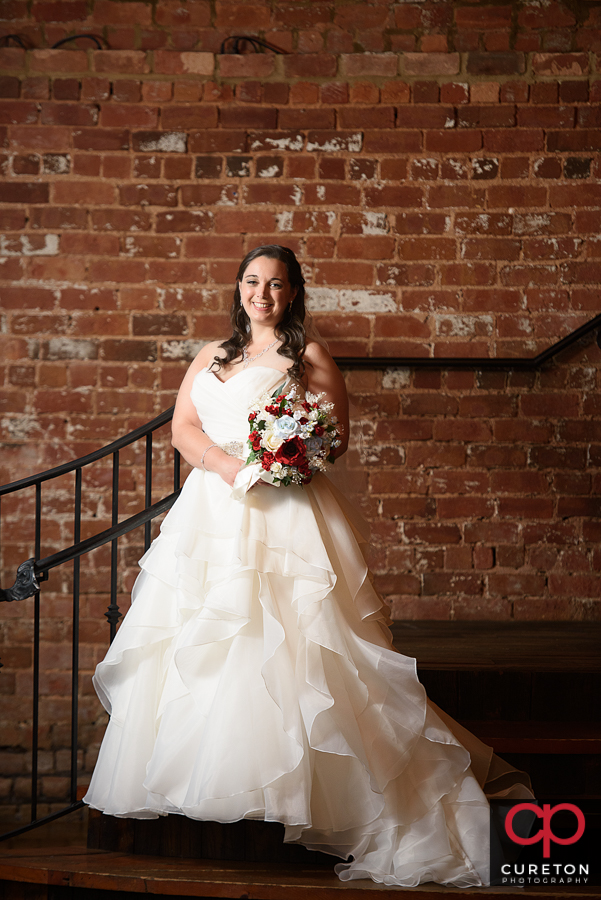 Bride on the steps inside the Old Cigar Warehouse in downtown Greenville,SC.
