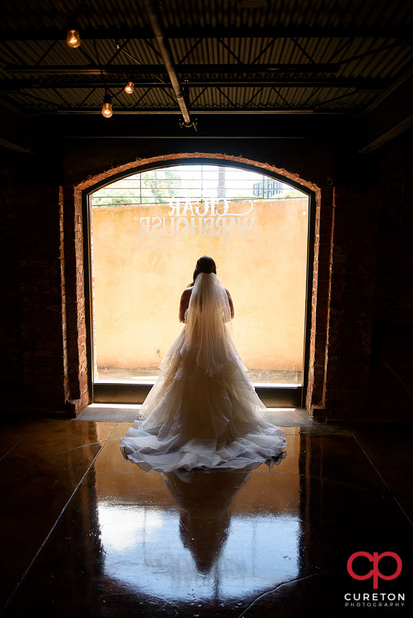 Bride in front of a window at Old Cigar Warehouse.