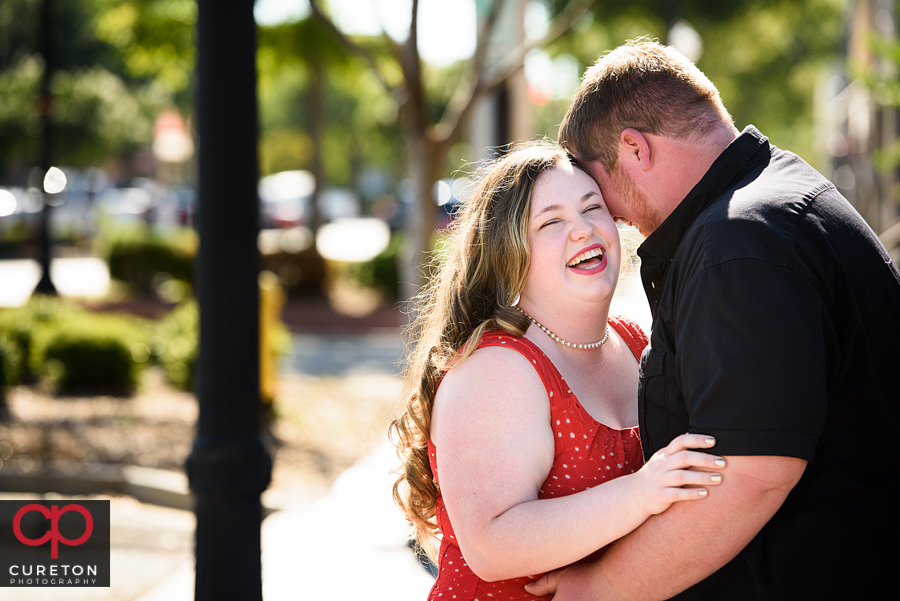 Engaged couple laughing at their Old Cigar Warehouse engagement session.