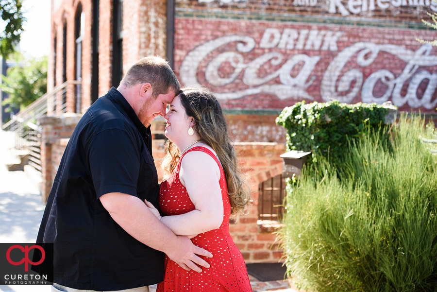 Engaged couple hugging at their Old Cigar Warehouse engagement session.