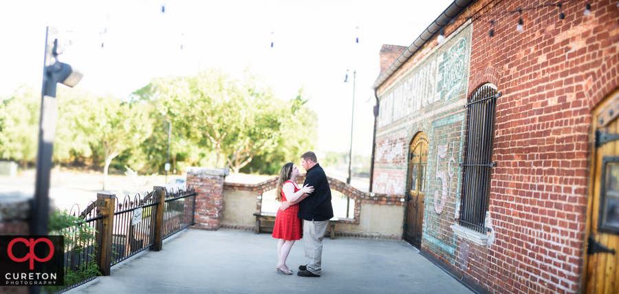 Engaged couple on the deck of The Old Cigar Warehouse.