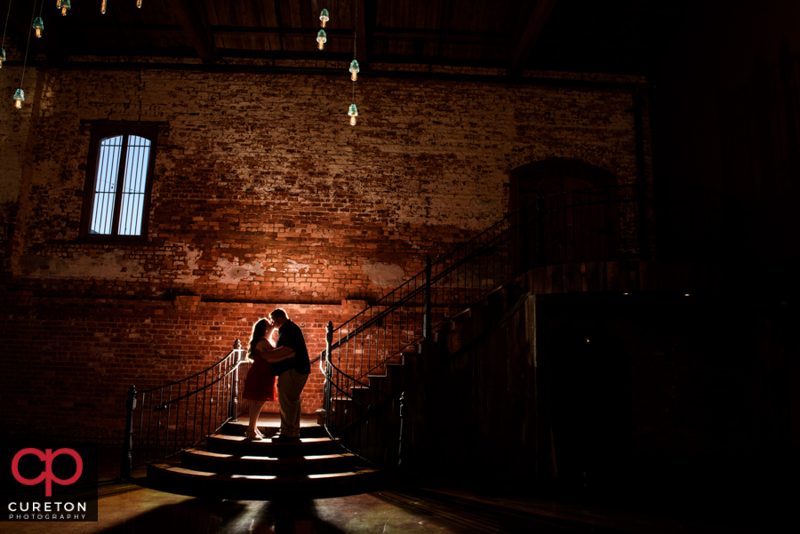 Epic shot of a couple during their engagement session at The Old Cigar Warehouse.