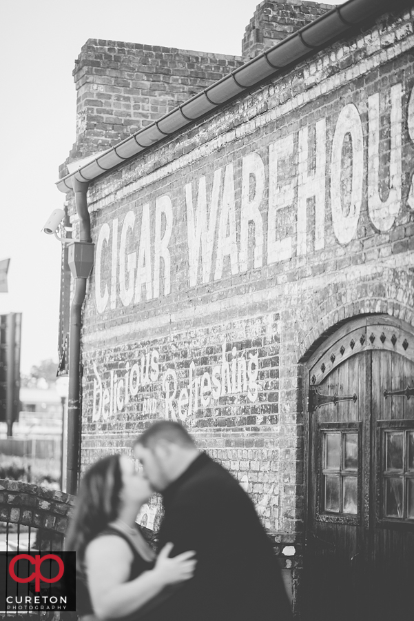 Black and white vintage photo of a couple during their engagement session at The Old Cigar Warehouse.