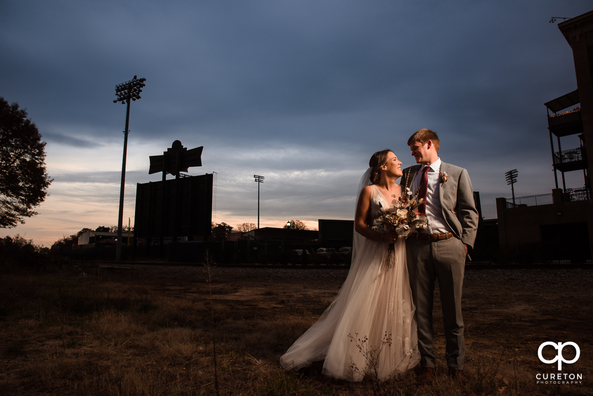 Husband and wife at sunset after their wedding ceremony at The Old Cigar Warehouse in Greenville,SC.