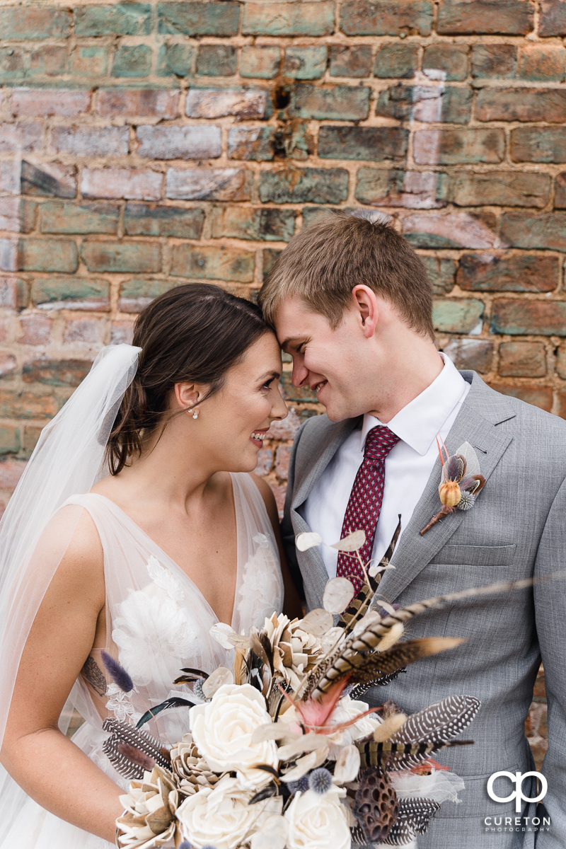 Bride and groom cuddling after their wedding.