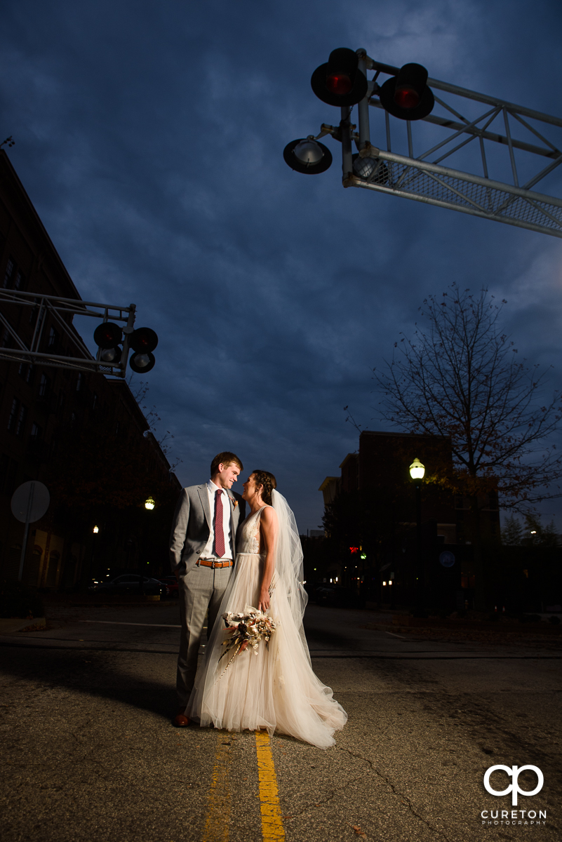 Bride and groom standing in the middle of the Main Street in downtown Greenville,SC.