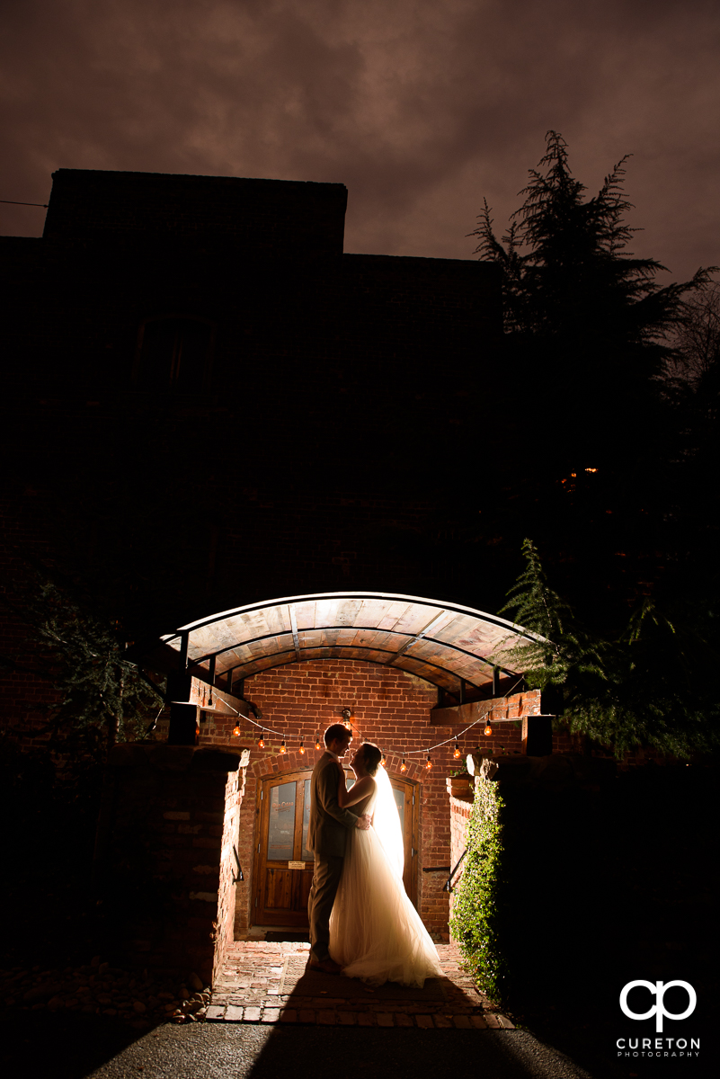 Groom and bride at sunset after their wedding ceremony at The Old Cigar Warehouse in Greenville,SC.