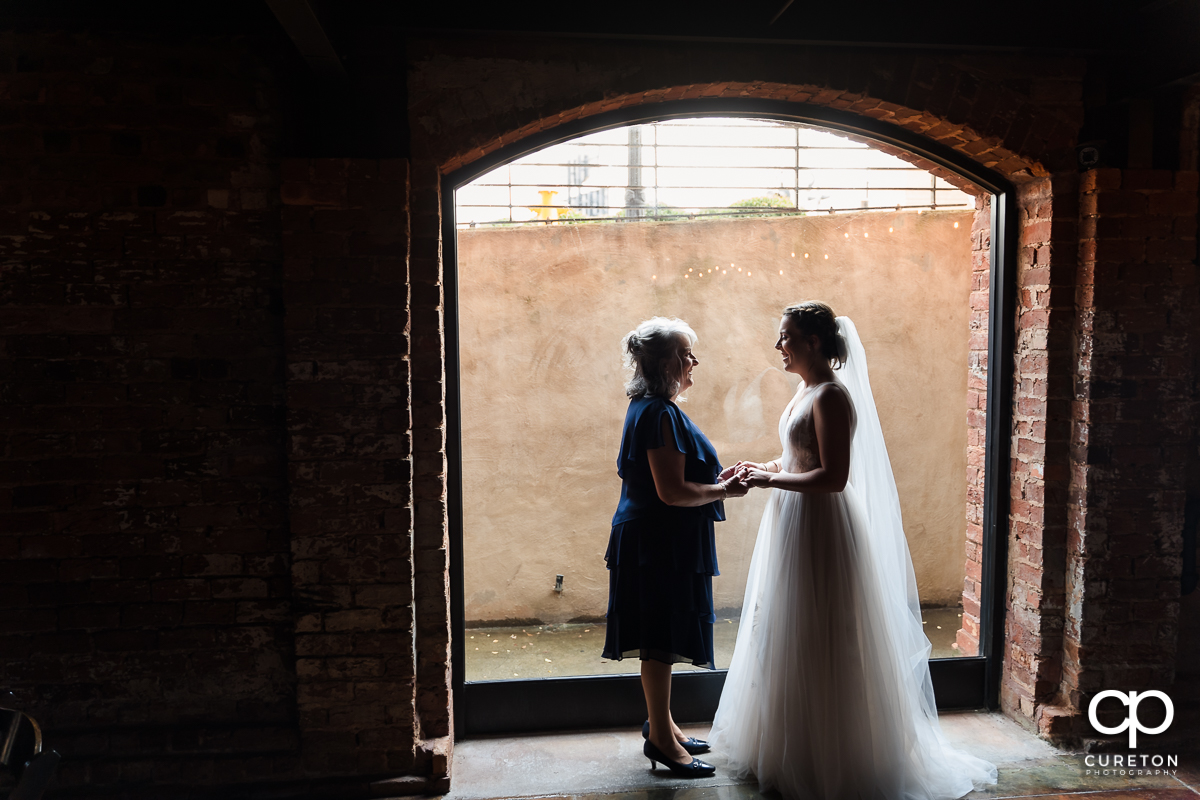 Bride and her mother standing in the window at The Old Cigar Warehouse.