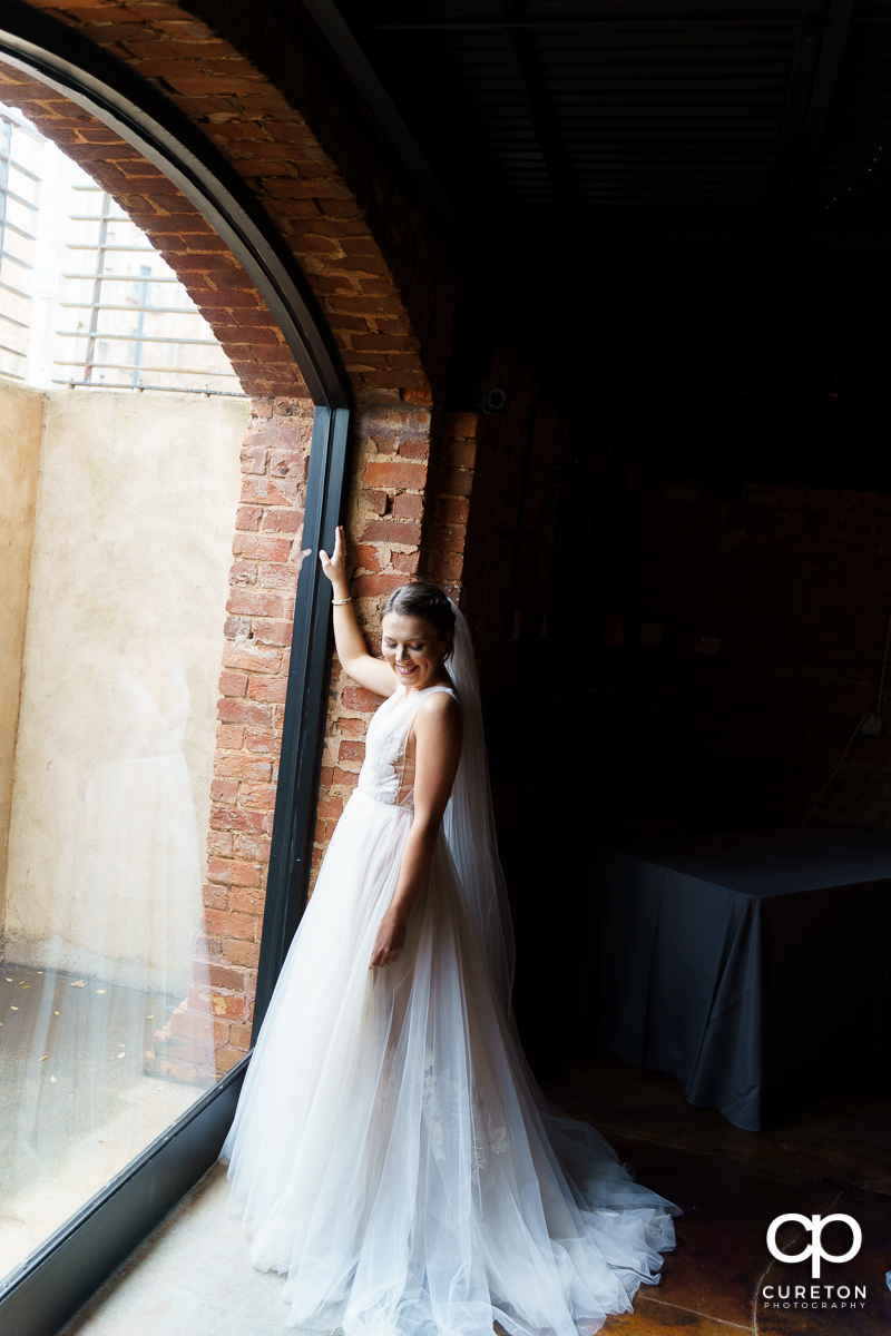 Bride standing in the window of The Old Cigar Warehouse.