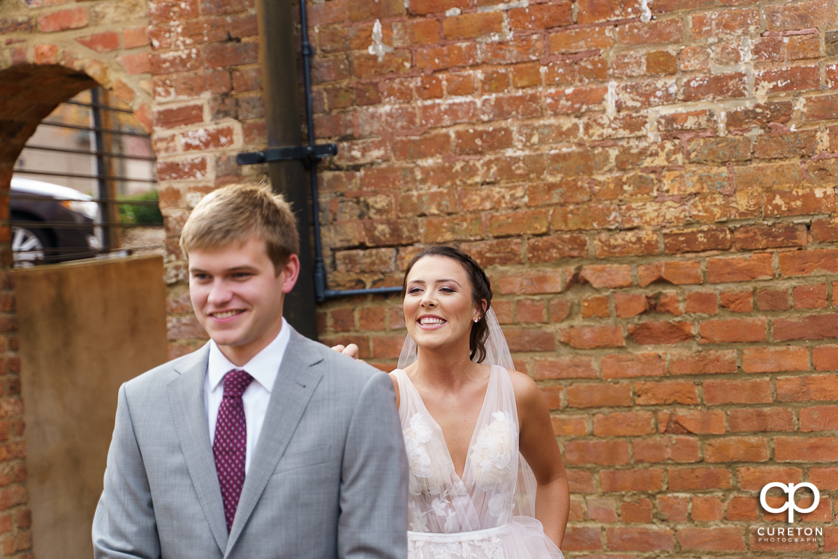 Bride walking up to the groom for a first look before the Old Cigar Warehouse wedding.