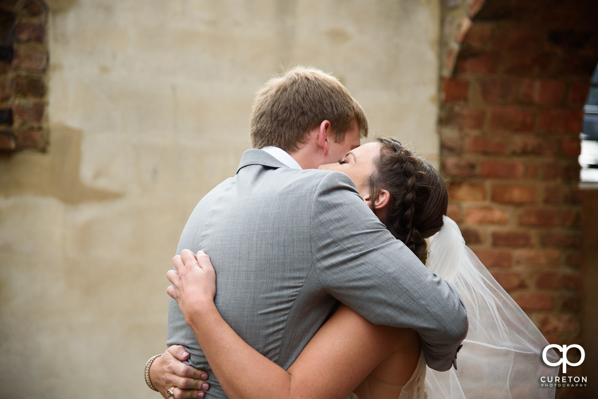 Bride hugging the groom at the first look.