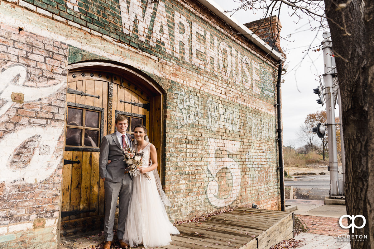 Bride and groom standing on the back deck of The Old Cigar Warehouse.