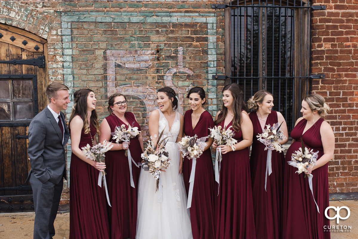 Bride laughing with her bridesmaids.