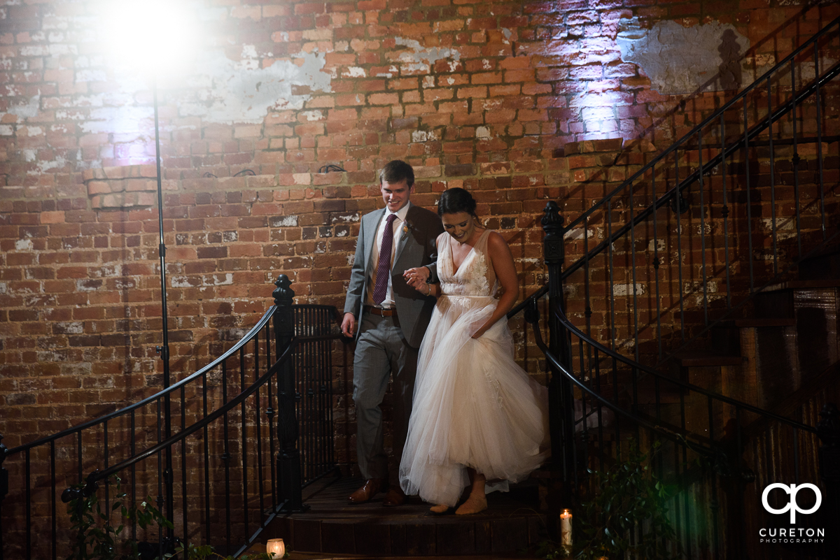 Bride and groom making an entrance into the reception.