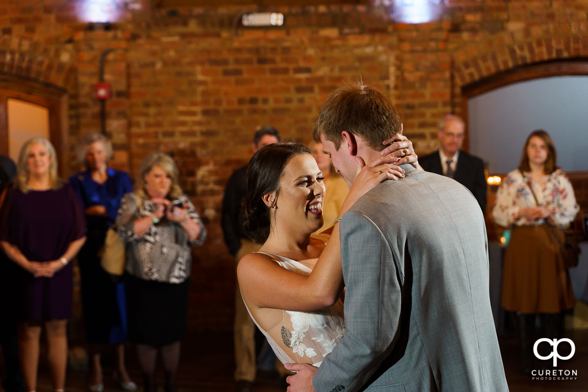 Bride laughing during the first dance at the reception.