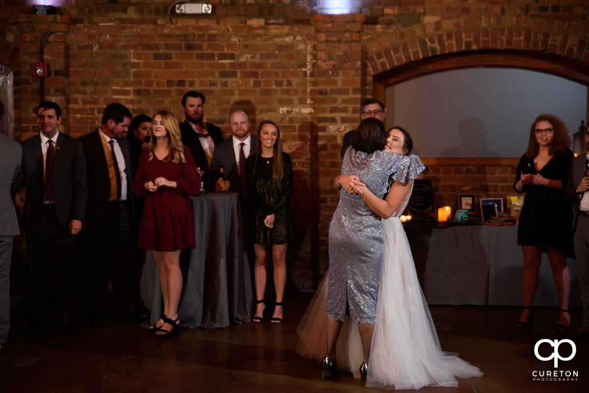 Bride hugging the groom's mom.