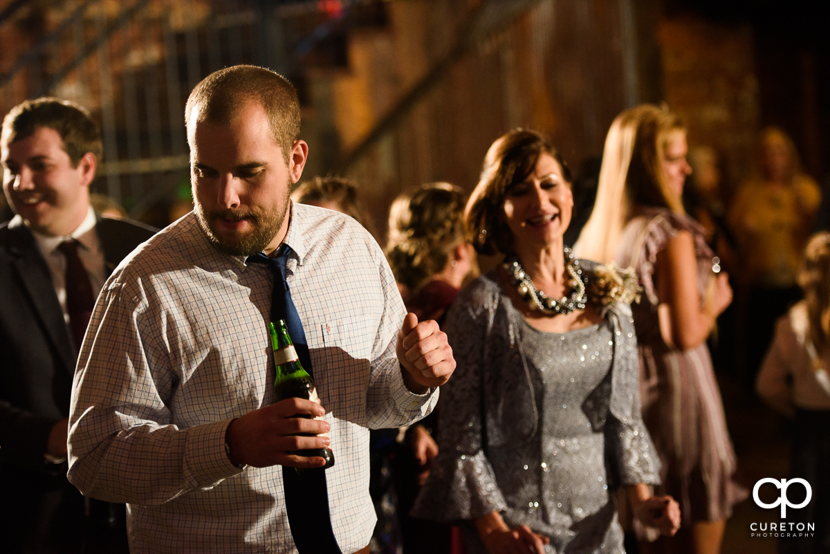 Guests dancing to the sounds of Jumping Jukebox at the Old Cigar Warehouse reception.