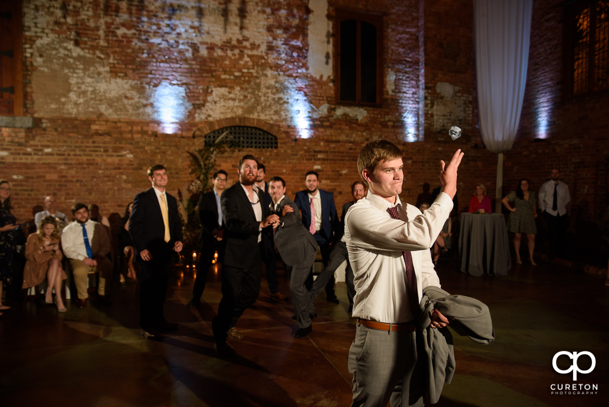 Groom tossing the garter.