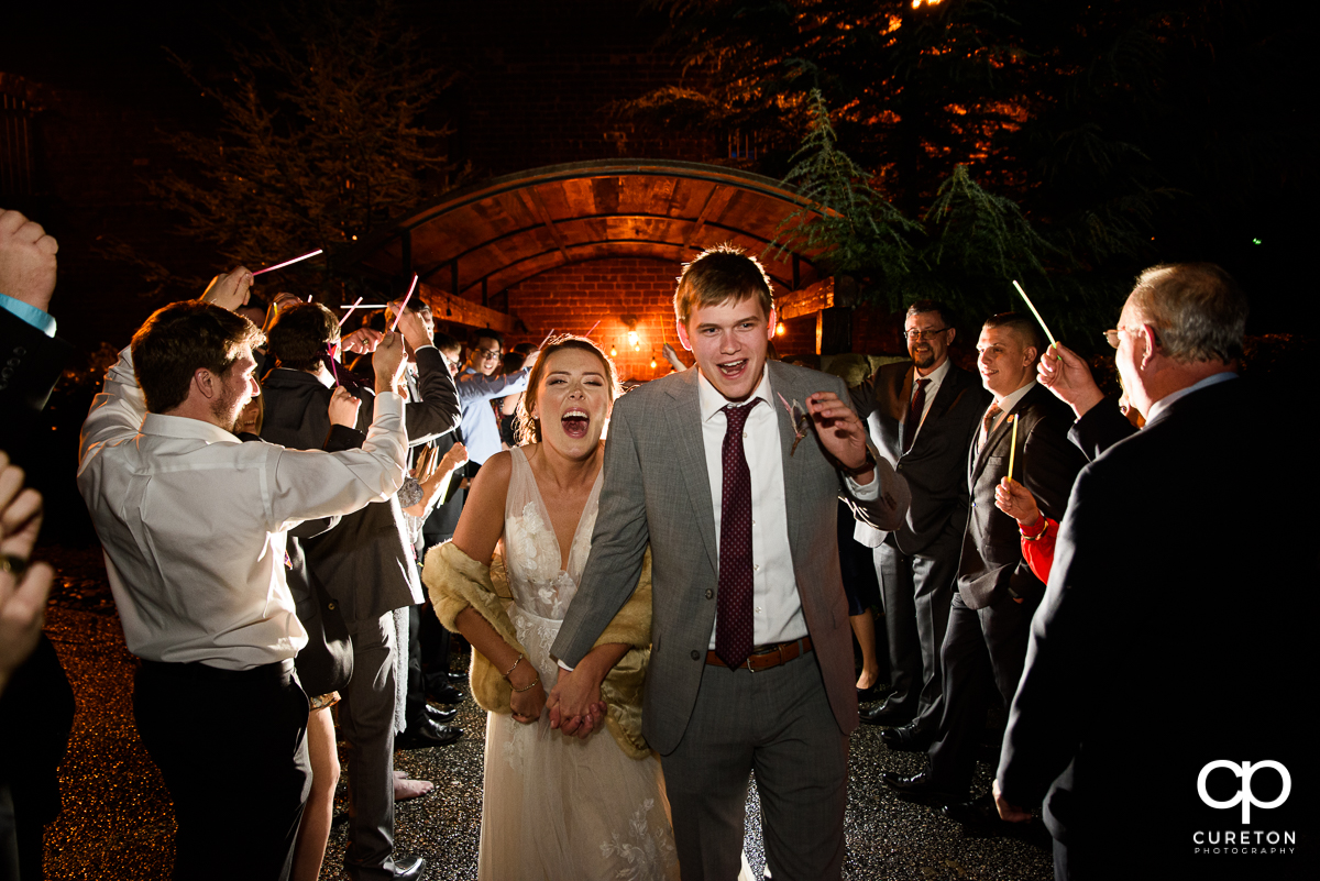 Bride and groom making a grand exit from their wedding reception.