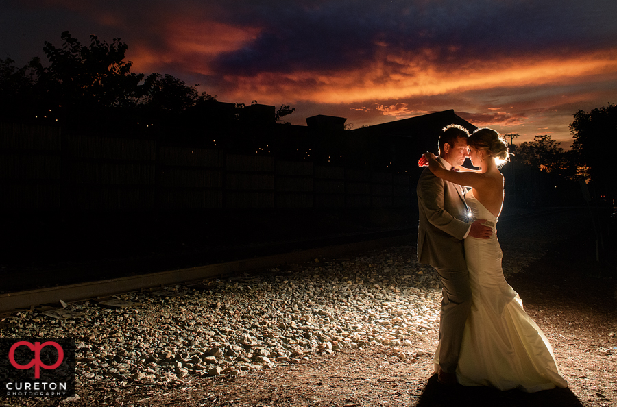 Bride and Groom dancing at sunset after their Old Cigar Warehouse wedding in downtown Greenville,SC.
