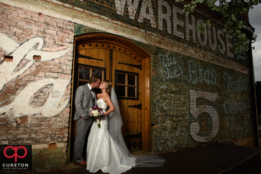 Bride and Groom kissing in downtown Greenville.