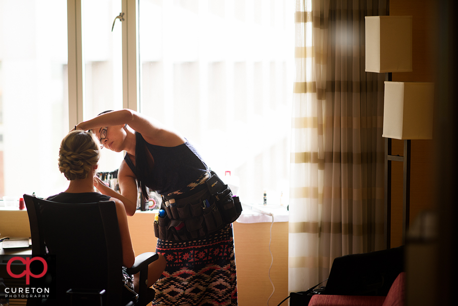 Katie Cotton applying bridal makeup.