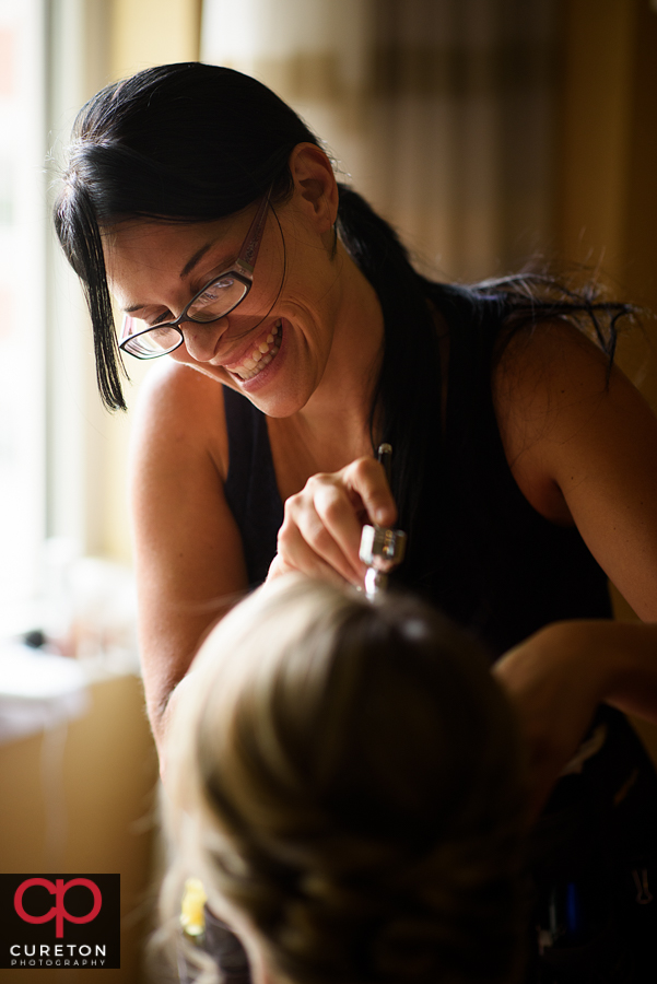 Katie Cotton from Cotton Rouge and Co. applying airbrush bridal makeup in downtown Greenville,SC.