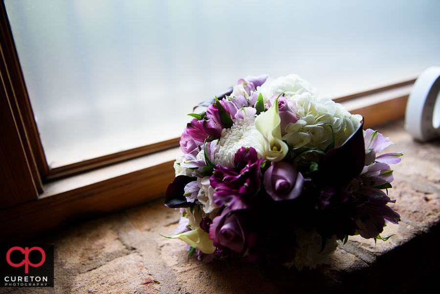 The bride's bouquet sitting in the window.