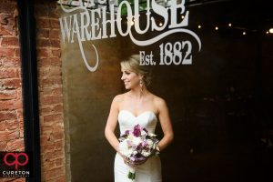 Bride standing in the window of the Old Cigar Warehouse.
