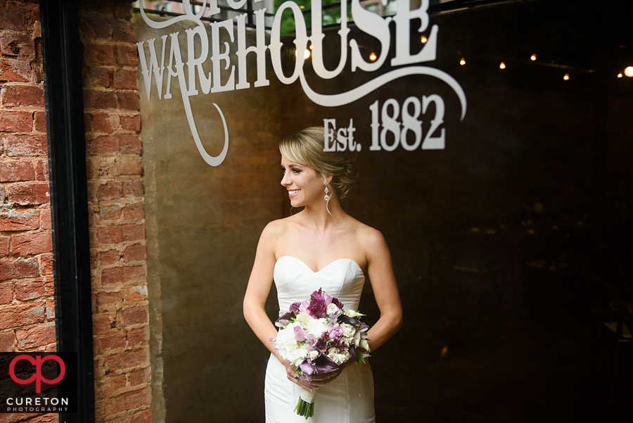 Bride standing in the window of the Old Cigar Warehouse.
