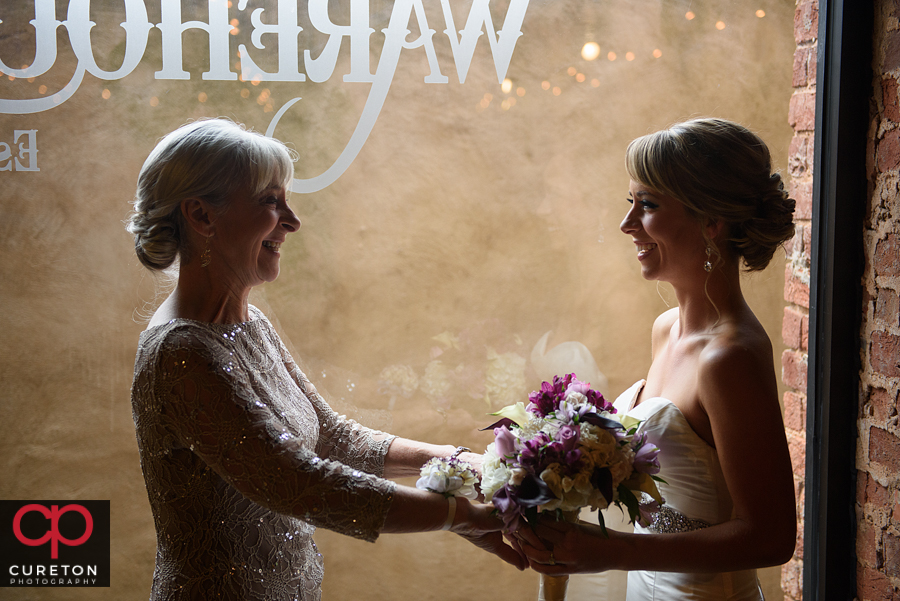 Bride and her mom standing in the window.