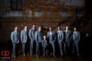 Groomsmen on the steps at Old Cigar Warehouse.