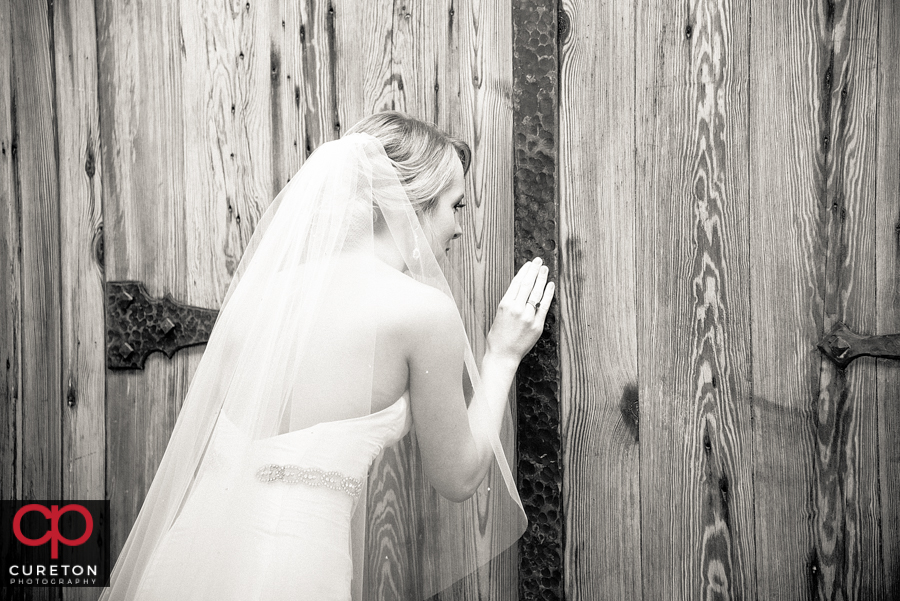 Bride peeking through the door before walking down the aisle.