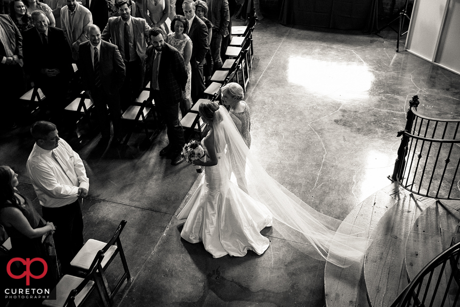 Bride and her mom walking down the aisle.