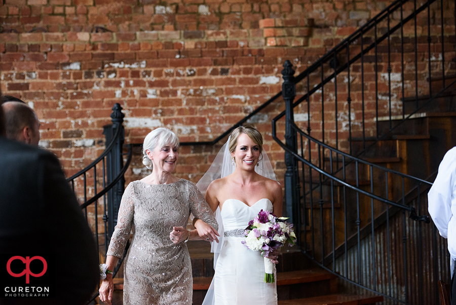 Bride and her mom walking down the aisle.