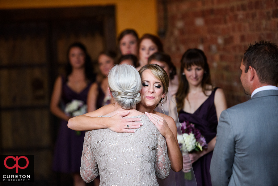 Bride and her mom walking down the aisle.