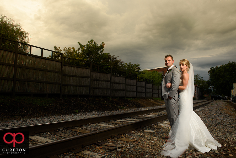 Epic shot of the bride and groom on the tracks.