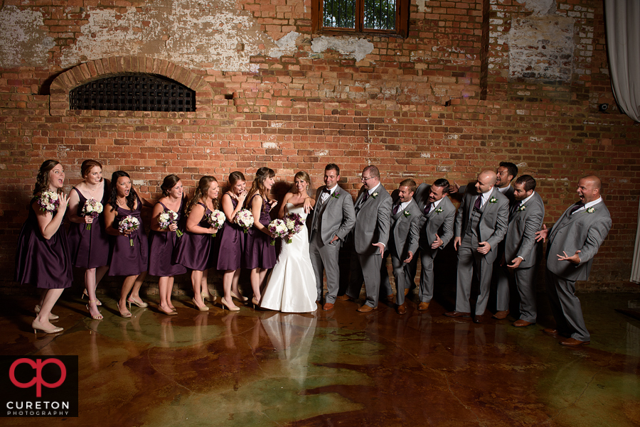 Wedding party looking at the ring.