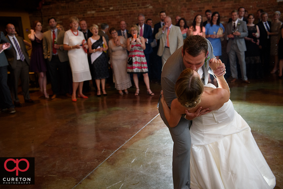 Groom dips his bride.