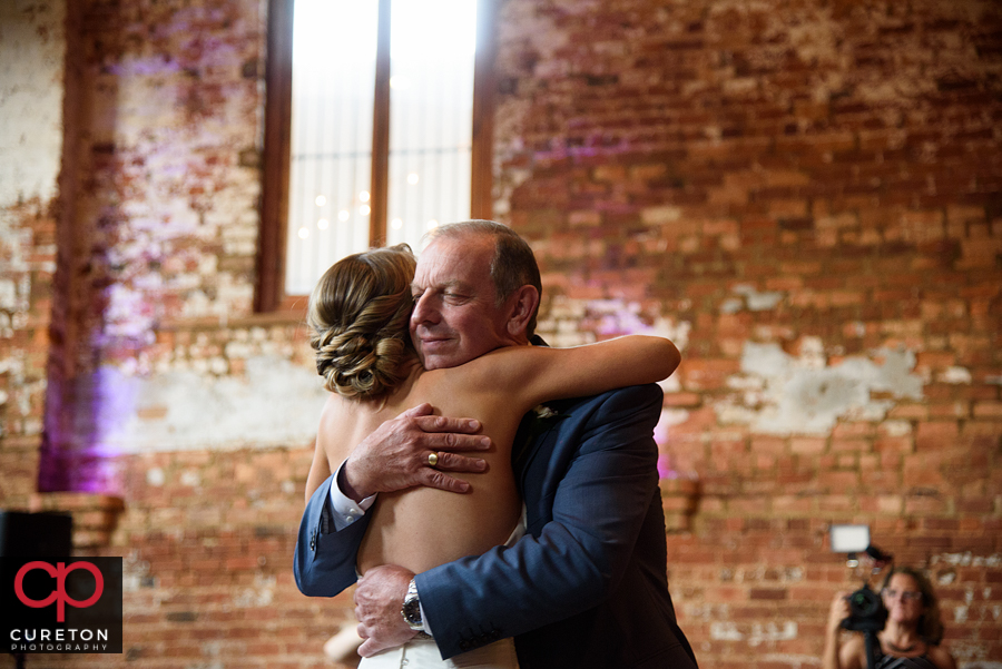 Bride and the groom's dad sharing a dance.