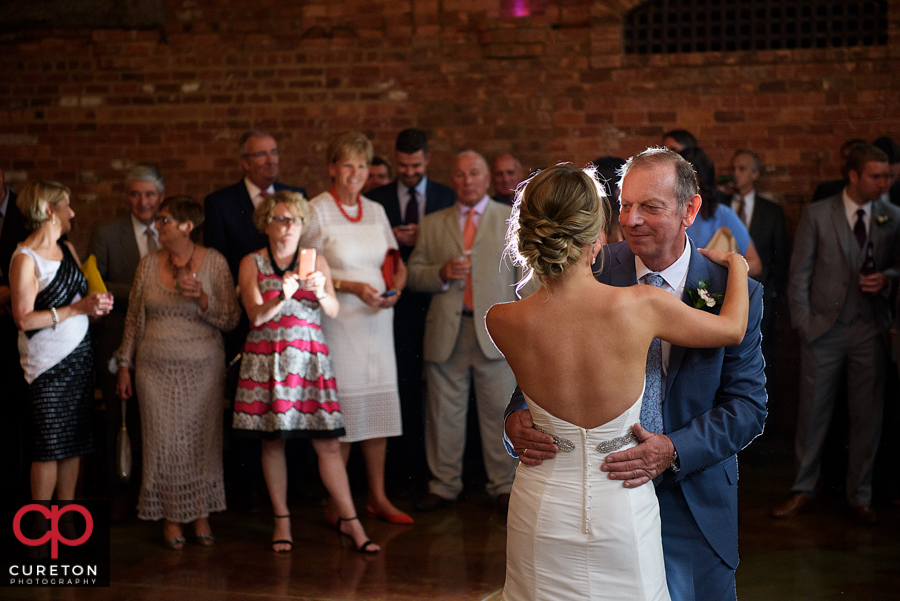 Bride and the groom's dad sharing a dance.