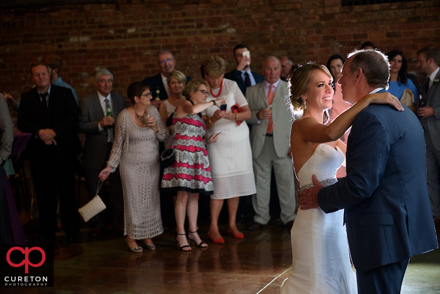 Bride and the groom's dad sharing a dance.