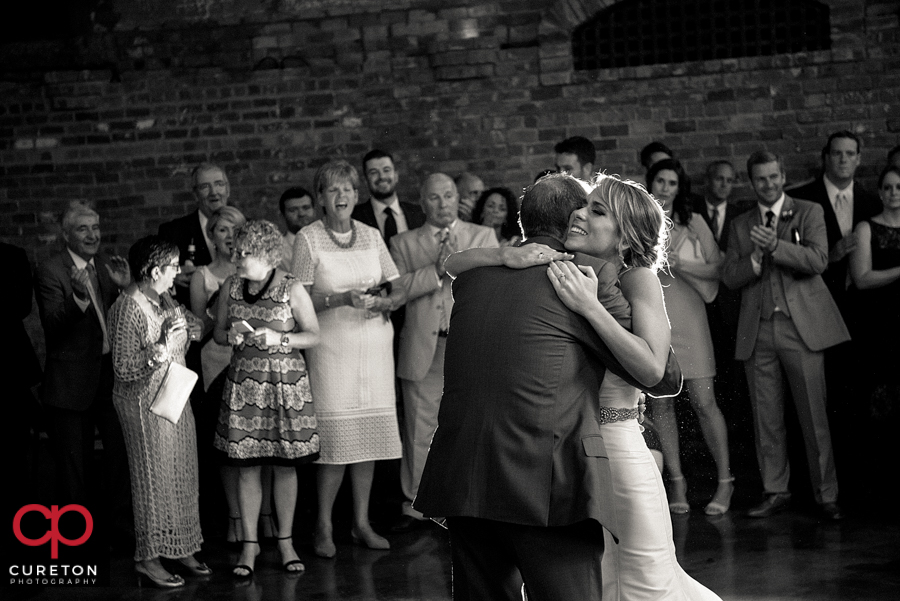 Bride and the groom's dad sharing a dance.