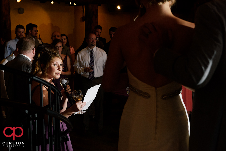 The maid of honor toasting the couple.