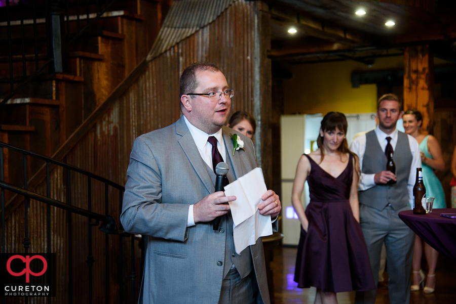 The best man giving the couple a toast.