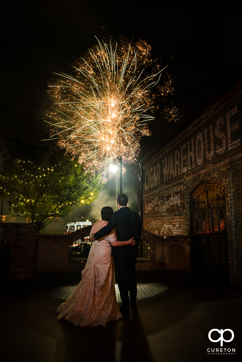 Bride and groom watching fireworks in downtown Greenville,SC after their wedding at The Old Cigar Warehouse in downtown Greenville,SC.