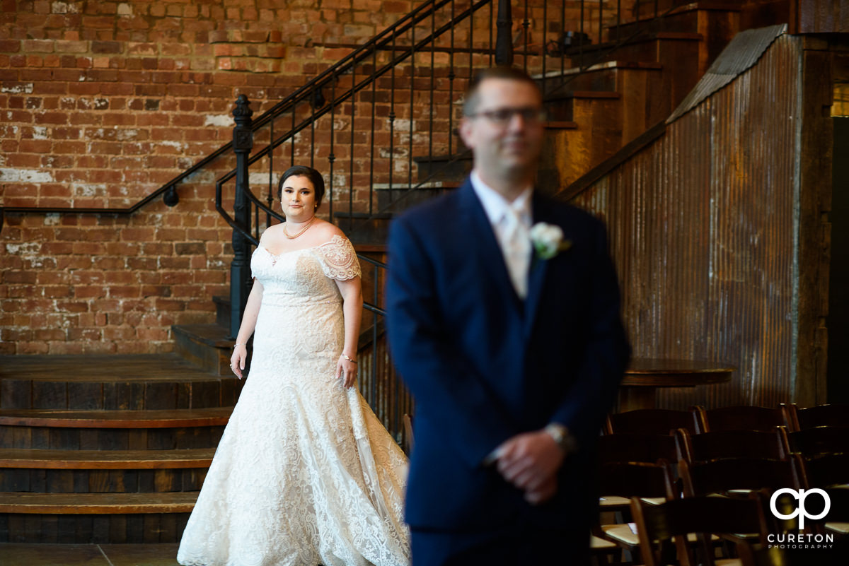 Bride walking up to her groom at a first look.