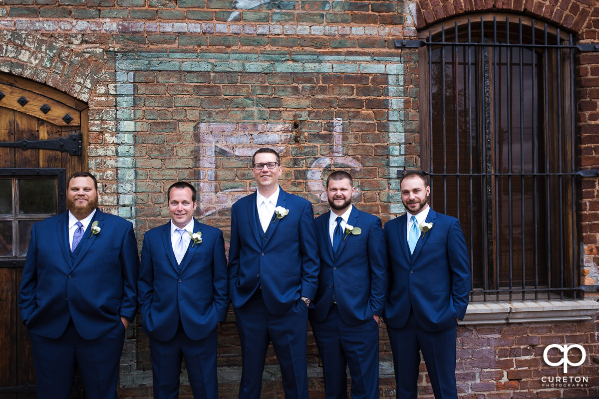 Groom and groomsmen on the deck of The Old Cigar Warehouse.